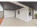 Open carport showcasing the home's exterior and features and the home's side entry at 8108 Fir Dr, Tampa, FL 33619