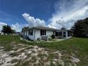 Lush yard with an enclosed lanai, perfect for outdoor entertaining and enjoying the scenery at 1106 Trellis Ave, Spring Hill, FL 34606