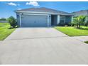 Inviting single-story home with a spacious driveway, two-car garage, and beautifully manicured front lawn at 11940 Stone Pine St, Riverview, FL 33569