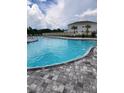 Community pool with brick surround, perfect for hot summer days at 11940 Stone Pine St, Riverview, FL 33569