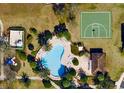 Aerial view showcasing community amenities including a refreshing swimming pool and basketball court, promoting an active lifestyle at 12249 Country White Cir, Tampa, FL 33635
