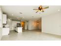 Open-concept living space seamlessly connects the kitchen, dining, and living areas with tile floors at 13408 Nimble Minke # 155E, Riverview, FL 33579