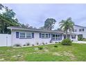 Charming single-story home featuring a well-manicured lawn and beautiful landscaping in the front yard at 1445 Coburn Dr, Tarpon Springs, FL 34689