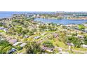 Expansive aerial view of a waterfront neighborhood with lush greenery and the city skyline in the distance at 1518 Cheyenne Ne St, St Petersburg, FL 33703