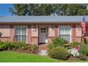 Close-up of home's front entrance with brick accents and well-maintained landscaping at 15316 Winding Creek Dr, Tampa, FL 33613