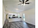Open-concept living space showcasing the kitchen with white cabinets and stylish wood-look floors at 1565 S Martin Luther King Jr Ave, Clearwater, FL 33756