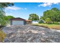 Beautiful single-story home with a brick driveway, lush lawn, and mature trees providing ample shade at 1710 Townsend St, Clearwater, FL 33755