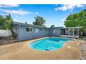 Inviting kidney-shaped pool surrounded by a spacious patio area perfect for outdoor entertaining and relaxation at 1710 Townsend St, Clearwater, FL 33755