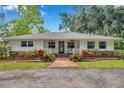 Inviting single-story home with landscaped front yard, a cozy porch, and beautiful curb appeal at 2140 Bow Ln, Safety Harbor, FL 34695