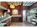 Cozy kitchen with wood paneling, granite countertops, and classic stained-glass pendant lighting at 2334 14Th N Ave, St Petersburg, FL 33713