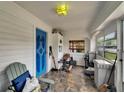 Bright and airy sunroom with tile flooring, multiple windows, and a striking blue entry door at 2334 14Th N Ave, St Petersburg, FL 33713