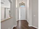 Inviting foyer with dark wood floors, high ceilings, and a chandelier light fixture at 2772 Golf Lake Dr # 03, Plant City, FL 33566