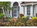 Close up of the front door of a property with screened entry and lush landscaping at 2772 Golf Lake Dr # 03, Plant City, FL 33566