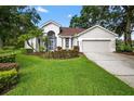 Well-maintained home with lush green lawn, mature landscaping, and a two-car garage at 2772 Golf Lake Dr # 03, Plant City, FL 33566