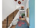 Bright entryway with high ceilings, modern staircase, and stylish decor creates a welcoming first impression at 2803 W Aquilla St, Tampa, FL 33629