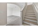 Bright entryway featuring wood-look floors, a staircase, and an archway at 3125 S Northview Rd, Plant City, FL 33566