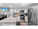 Modern kitchen with granite countertops, stainless steel appliances, and ample cabinet space at 3350 Fox Hunt Dr, Palm Harbor, FL 34683