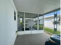 Covered carport area with a screened in porch and a golf cart inside at 34645 Camphor N Dr, Pinellas Park, FL 33781