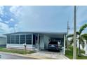 Inviting single-story home featuring a screened-in porch and convenient carport at 34645 Camphor N Dr, Pinellas Park, FL 33781