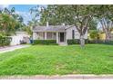 Traditional home featuring a green lawn and manicured shrubs in a peaceful neighborhood setting at 3503 W Palmira Ave, Tampa, FL 33629