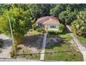 Aerial shot showcasing the property's mature trees, surrounding landscape, and a neatly maintained lawn at 3622 W Mullen Ave, Tampa, FL 33609