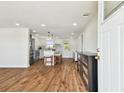 Spacious and updated living room featuring wood floors and an open entrance to the kitchen at 3850 Carioca Rd, Holiday, FL 34691