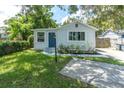 Charming single-story home with a well-manicured lawn and a vibrant blue front door at 4044 56Th N Ave, St Petersburg, FL 33714