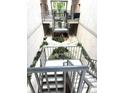 View of the complex courtyard showing landscaping and metal stairs at 4207 Winding Moss Trl # 201, Tampa, FL 33613