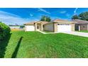 Single-story home with a well-maintained lawn and a two-car garage at 4928 Timber Way, Zephyrhills, FL 33542