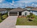 Well maintained home features a brick driveway, manicured lawn and a lush garden at 5329 Senza Trl, Palmetto, FL 34221