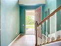 Bright foyer with tile flooring, staircase, and view of the front door at 5830 100Th E Ave, Parrish, FL 34219