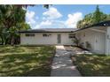 Beautiful home featuring fresh landscaping and a quaint covered outdoor deck at 6108 Oak Ridge Ave, New Port Richey, FL 34653
