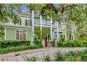 Charming two-story home with a double porch, landscaped yard and mature trees in a desirable location at 6220 Bayshore Blvd, Tampa, FL 33611