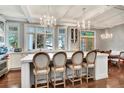 Elegant kitchen featuring a large island, stylish seating, hardwood floors, and windows at 6220 Bayshore Blvd, Tampa, FL 33611