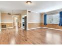 Spacious living room featuring hardwood floors, crown molding, and natural light at 6360 1St N St # 202, St Petersburg, FL 33702