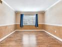 Bright living room with hardwood floors and natural light through the window at 6360 1St N St # 202, St Petersburg, FL 33702