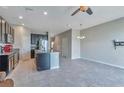 Open concept kitchen with stainless steel appliances, island with sink, and breakfast bar at 6909 Holly Heath Dr, Riverview, FL 33578
