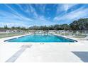 Large community pool with plenty of lounge chairs and a clear blue sky above at 7000 Lafayette N, Pinellas Park, FL 33781