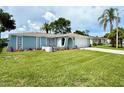 Classic one-story home offering a well-kept lawn, decorative landscaping, and an attached two-car garage at 7314 Ivanhoe Dr, Port Richey, FL 34668