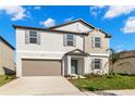 Charming two-story home features a well-manicured lawn and a two-car garage at 8918 Parsons Hill Blvd, Wesley Chapel, FL 33545