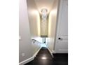 Elegant staircase featuring a modern chandelier and dark wood steps at 9005 W Flora St, Tampa, FL 33615