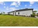 Expansive backyard with lush lawn and manicured landscaping under a clear blue sky at 10282 Echo Dock Loop, San Antonio, FL 33576