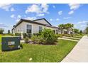 Landscaped single-story home with well-maintained lawn and a brick-paved driveway at 10282 Echo Dock Loop, San Antonio, FL 33576