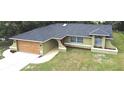 Well-maintained single-story home boasts a modern roof, two-car garage, and mature landscaping at 10287 Fordham St, Spring Hill, FL 34608