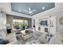 Bright living room showcasing a large entertainment center, blue accent wall, and access to the outdoor patio at 10450 Highland Park Pl, Palmetto, FL 34221
