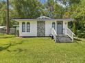 Charming single-story home with stone accents, gray front door, and a well-maintained lawn at 111 E Early St, Brooksville, FL 34601
