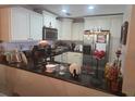 Well-lit kitchen featuring granite countertops and stainless steel appliances and ample storage at 12133 Spartan Way # 203, Hudson, FL 34667