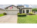 Beautiful house featuring a two-car garage, well-maintained lawn, and inviting curb appeal at 12251 Duckett Ct, Spring Hill, FL 34610