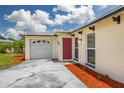 Close up view of a well-maintained one story home and manicured landscaping at 12877 Palm Dr, Largo, FL 33774