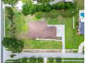Aerial view of home with a well-maintained lawn, mature trees, and landscaping at 13102 Done Groven Dr, Dover, FL 33527